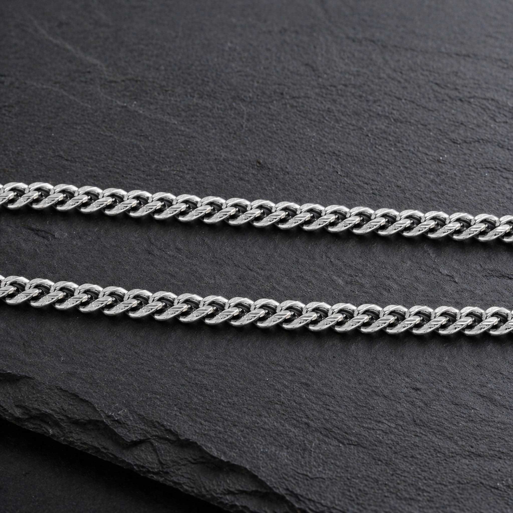 silver cuban link chain on slate background