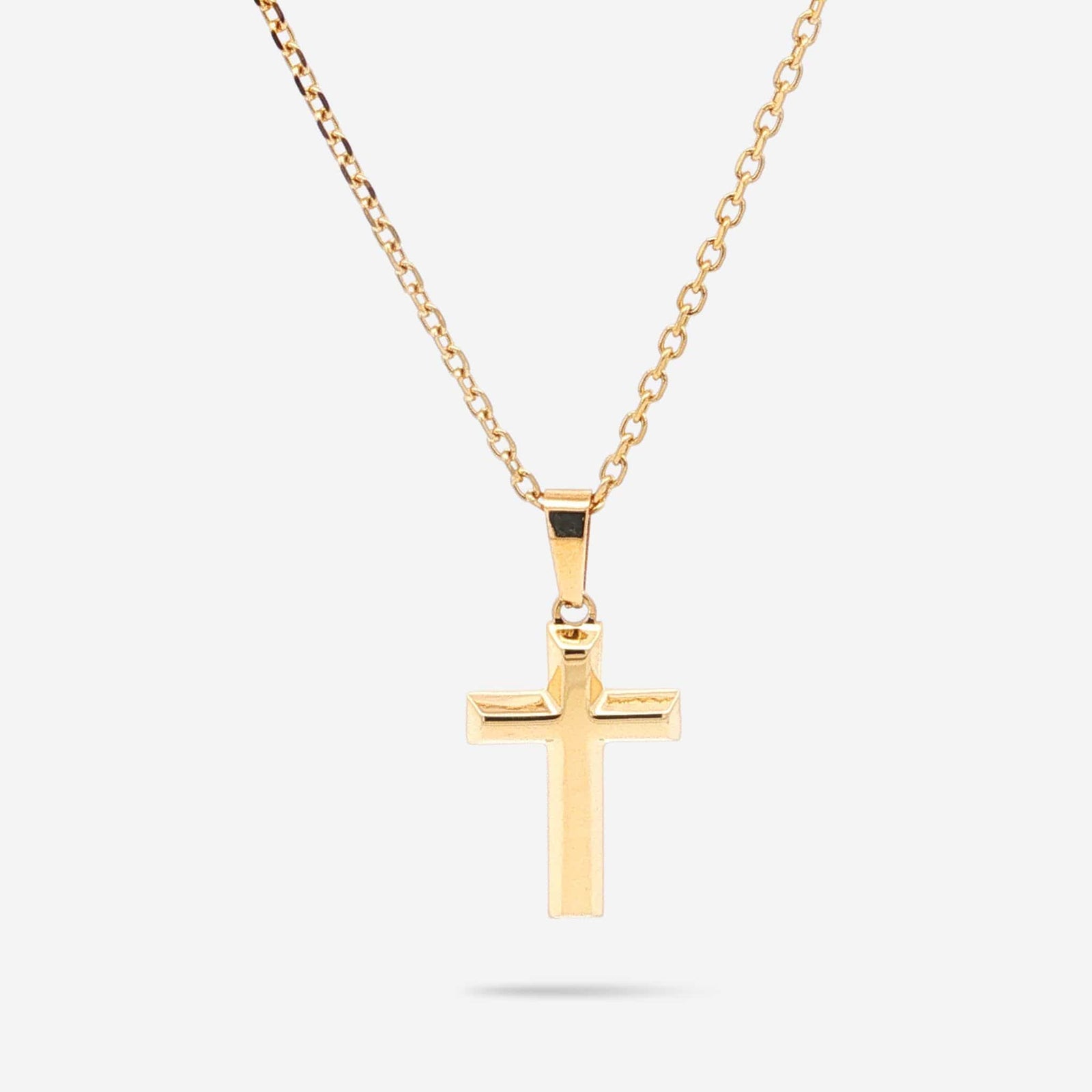 A polished yellow gold cross pendant necklace on a matching gold chain, displayed against a clean, light gray background.
