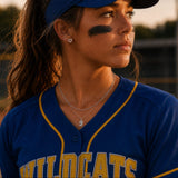Softball player in a blue sports jersey wearing a necklace with a number 9 and home plate earrings 