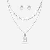 Silver necklace with number 9 pendant and matching home plate earrings on a white background