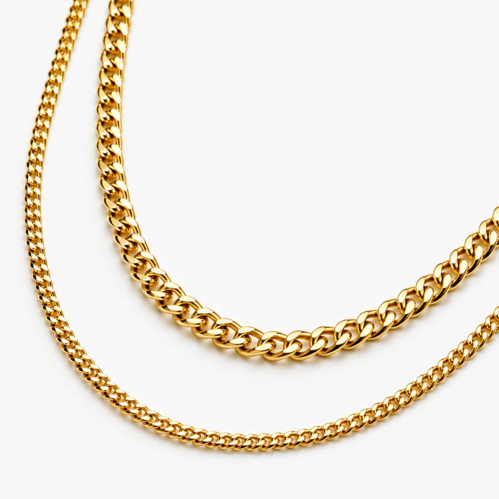 two cuban chain necklaces on white background